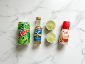 mountain dew cream soda dirty soda ingredients — dew can, vanilla syrup, lime, coffee-mate