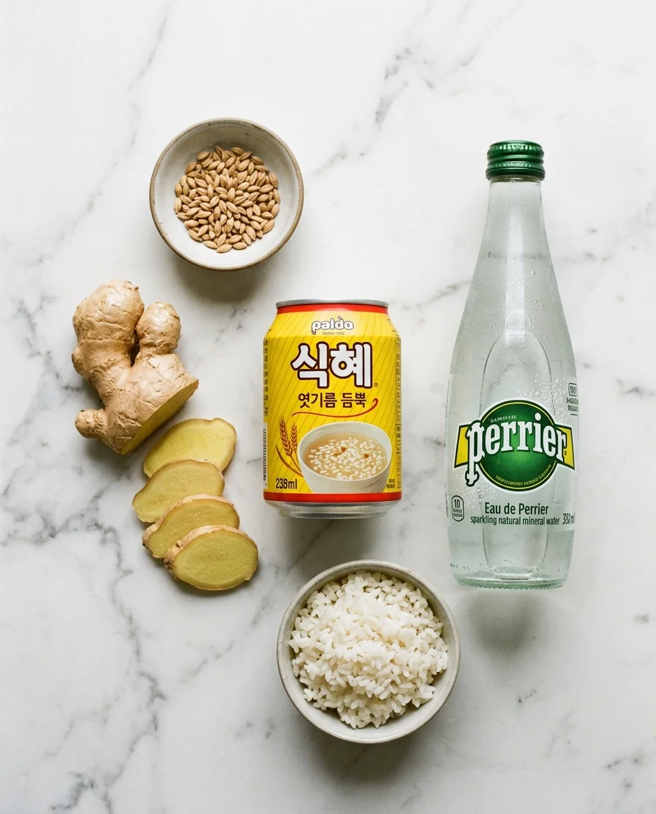 sikhye drink ingredients with Korean sikhye can, fresh ginger, and sparkling water on marble surface