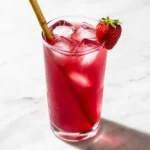 strawberry iced tea recipe in tall glass with fresh strawberries and condensation on white marble
