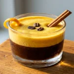 Viral egg coffee recipe with golden egg foam over iced coffee in a rocks glass