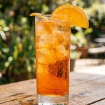 Cortisol cocktail served over ice in a tall glass with an orange slice