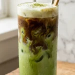 Dirty matcha latte layered with espresso and matcha in a tall glass