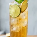 Ginger beer recipe homemade in a tall glass with lime and mint garnish