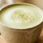 Matcha adaptogen drink recipe latte with bamboo whisk