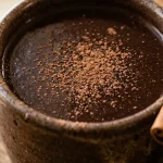 Mushroom adaptogen drink recipe in a mug with cacao and cinnamon