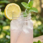 Pink salt trick recipe in a mason jar with lemon and mint garnish